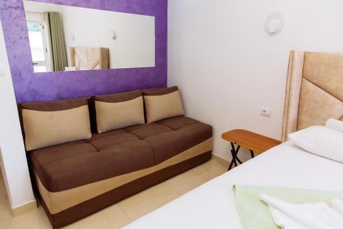 a living room with a couch and a mirror at Mala Plaza in Ulcinj