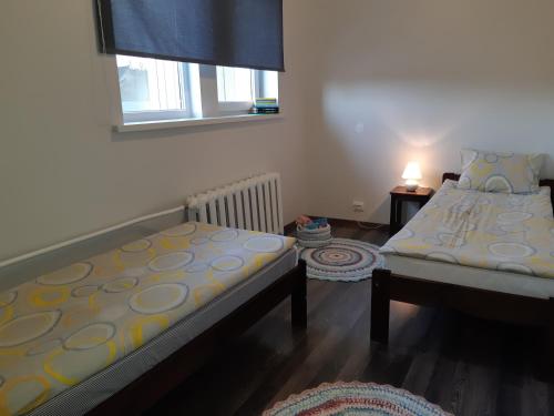 a bedroom with two beds and a window at Ovelia B&B in Kuressaare