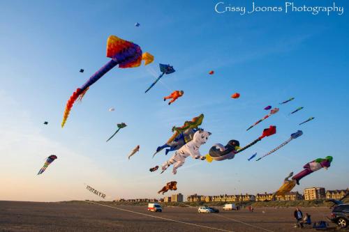 a bunch of kites flying in the sky at Seaside Loft in Lytham St Annes
