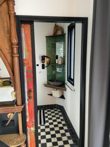 a hallway with a black and white checkered floor at Morpheus in Amsterdam