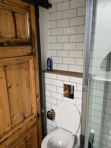 a bathroom with a white toilet and a door at Morpheus in Amsterdam