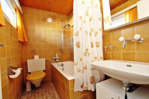 a bathroom with a sink and a toilet and a sink at Tgesa Sunnmatt Nr. 13 in Savognin