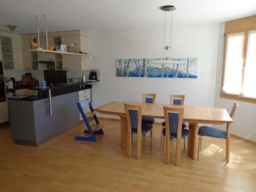 a kitchen and dining room with a table and chairs at Sot Spondas 15 in Savognin