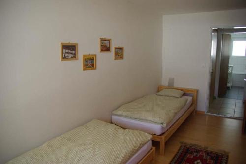 2 Einzelbetten in einem Zimmer mit Flur in der Unterkunft Tgesa Marlotscha in Savognin