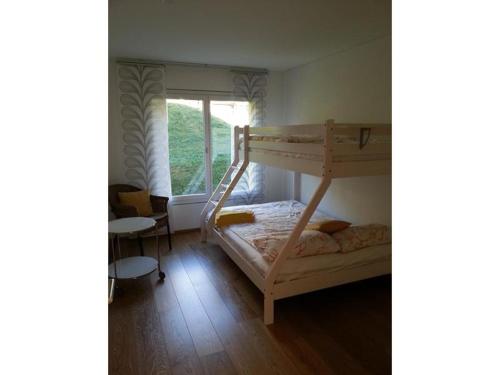 a bedroom with two bunk beds and a window at Canetel 11 Whg 3 in Savognin