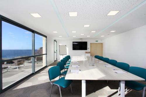 a conference room with a long table and chairs at Village de vacances Paese di Lava, Grand Ajaccio in Alata