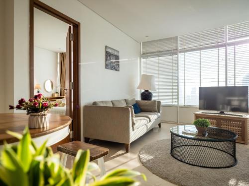 a living room with a couch and a tv at The Penthouse KLCC in Kuala Lumpur