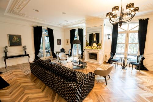 a living room with a couch and a fireplace at Arté Boutique Hotel in Tirana