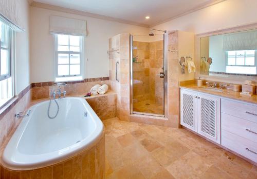 a large bathroom with a tub and a shower at Howzat! by Island Villas in Saint James