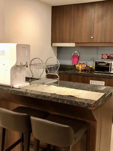 a kitchen with a counter with chairs and a sewing machine at Sky D'Mont Suites in Genting Highlands