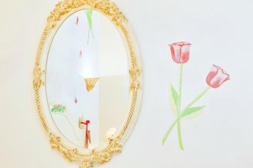 a gold mirror with a cross and flowers on it at Archontiko Kymis Boutique Hotel in Kymi