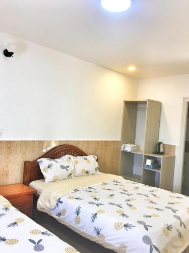 a bedroom with two beds in a room at Hoang Vu Guest House in Da Lat
