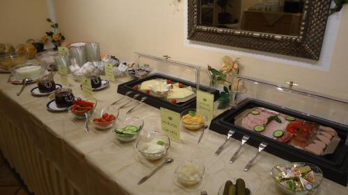 a table with a buffet of food on it at Landhaus Klausnerhof Hotel Garni in Seefeld in Tirol