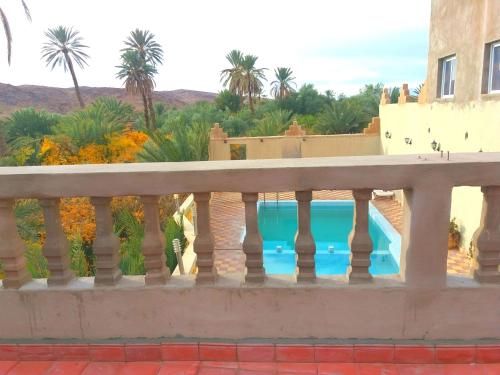a view from the balcony of a house with a swimming pool at Kasbah Elmehdaoui in Skoura