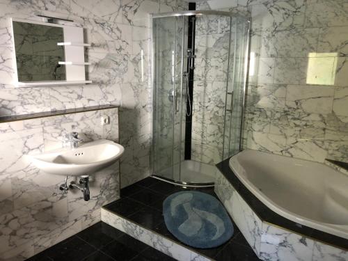 a bathroom with a sink and a shower and a tub at Wohnstrasse 11 in Vomperbach