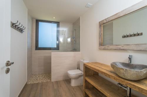 a bathroom with a sink and a toilet and a mirror at Nou Sol Solet in Begur