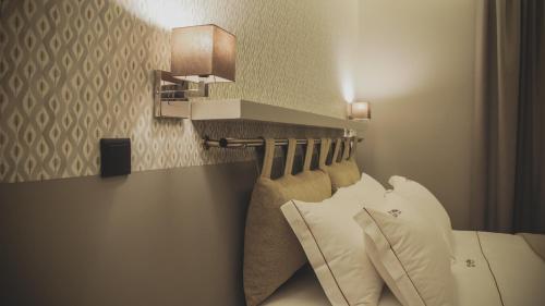 a hotel room with a bed with white pillows at Casal dos Capelinhos - Douro in Santa Marta de Penaguião