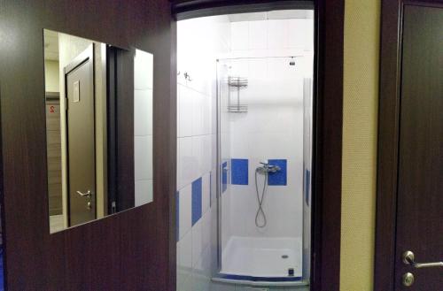 a bathroom with a shower with a toilet in it at Penates Hostel in Yekaterinburg