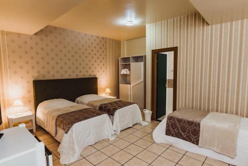 Ένα ή περισσότερα κρεβάτια σε δωμάτιο στο Cafezal Palace Hotel