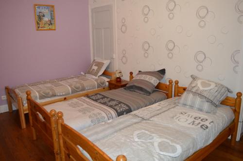 two twin beds in a room with at chambres d'hôtes des Bauges ROUTE 26 57 in La Motte-en-Beauges