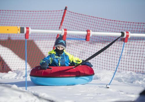 a person is riding in a tube in the snow at Privat u Babky in Ždiar