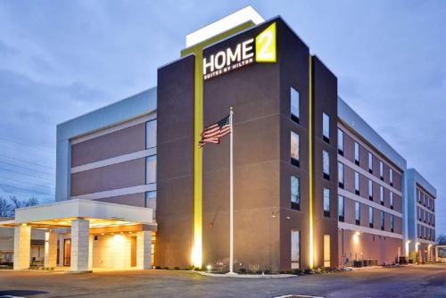 a hotel building with an american flag in front of it at Home2 Suites By Hilton Columbus/West, OH in Columbus