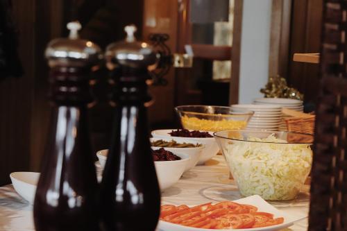 a table with bowls of food and bottles of beer at Hotel Martellerhof in Martello