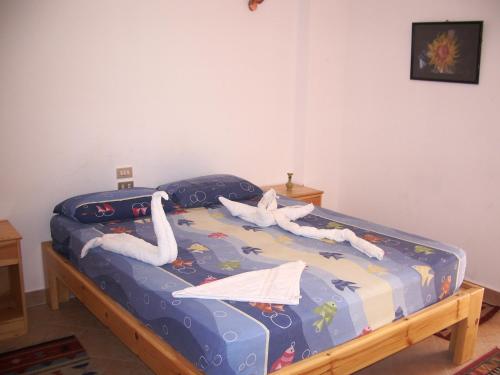 a bed with swans on it in a room at Star Of Dahab Hotel in Dahab
