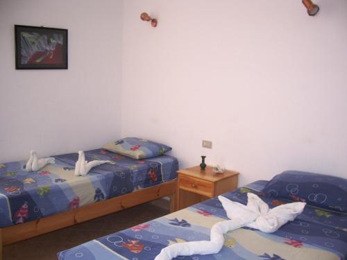 two beds in a room with towels on them at Star Of Dahab Hotel in Dahab
