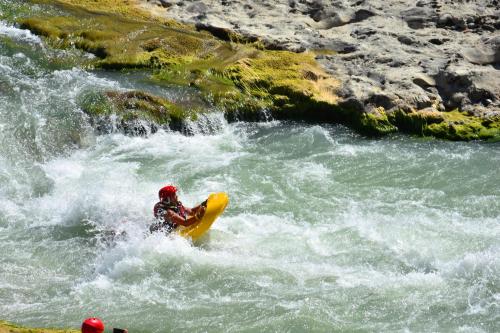 a person on a yellow raft in a river at Hotel Castle Park in Berat