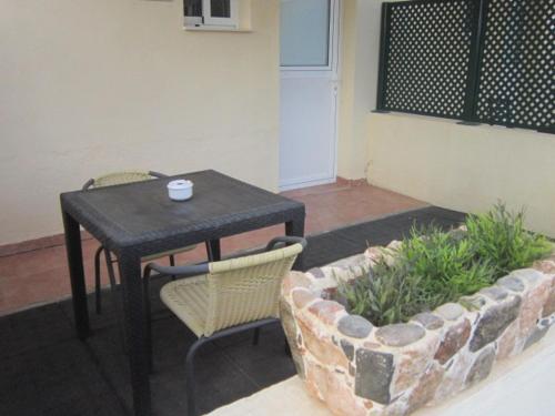 a black table and chairs and a table and a couch at La Estancia del Rincon in Cabo de Palos