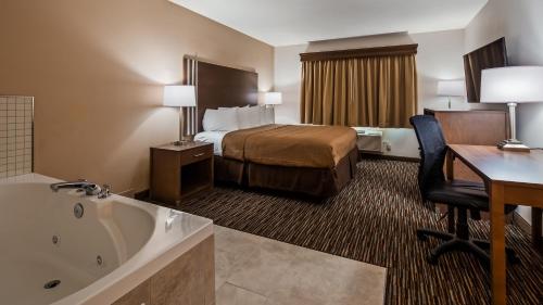 a hotel room with a bed and a bath tub at Best Western Brookfield in Brookfield