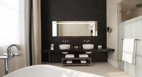 a bathroom with two sinks and a mirror at InterContinental Marseille - Hotel Dieu by IHG in Marseille