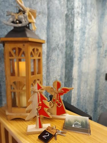 a wooden table with a candle and a lantern on it at Walizka Wspomnień in Karpacz