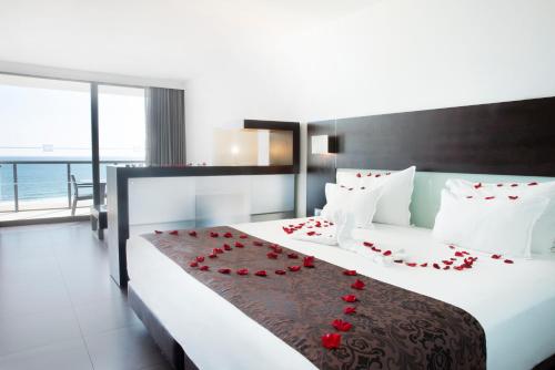Кровать или кровати в номере RR Hotel da Rocha