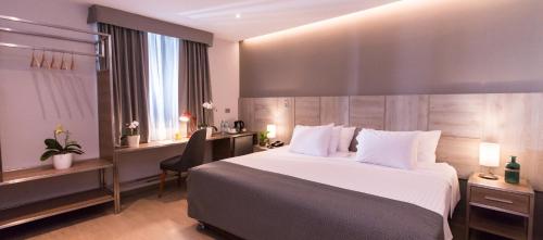 Una habitación de hotel con una cama grande y un escritorio. en Surya Lima, en Lima