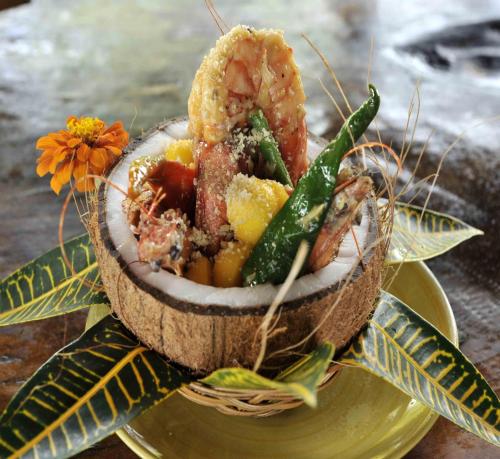 a bowl of food on a plate on a table at Badian Island Wellness Resort in Badian