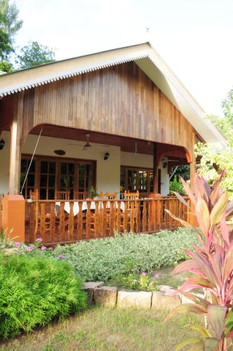 a house with a wooden fence in front of it at Casa De Leela Self Catering Guest House in La Digue