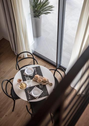 a table with a plate of food on a balcony at La Maggiolina Country House in Montelabbate