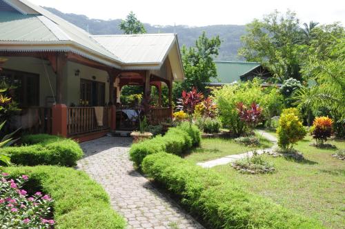 a garden in front of a house at Casa De Leela Self Catering Guest House in La Digue