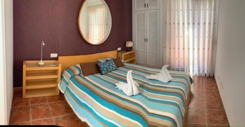 a bedroom with a large bed with white birds on it at Villa Mariña piscina climatizada opcional y 2 bicis gratuitas in Playa Blanca