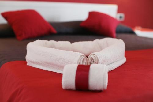a pair of folded towels on a bed at B&B Magma in Ercolano