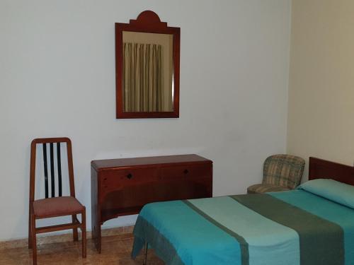 מיטה או מיטות בחדר ב-HOSTAL MARACAIBO