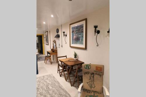 a living room with a table and a dining room at The Old Boat House in Carlingford