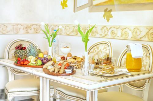 a breakfast table with food and drinks on it at Archontiko Kymis Boutique Hotel in Kymi