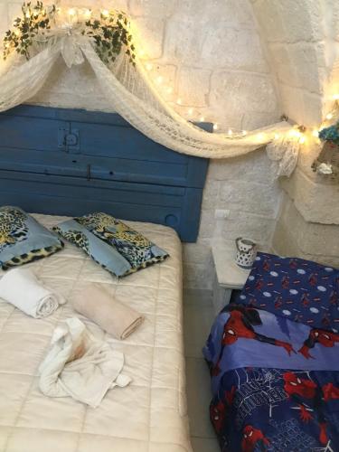 a bedroom with two beds and a baby on it at Palazzo Savoia 1856 in Fasano
