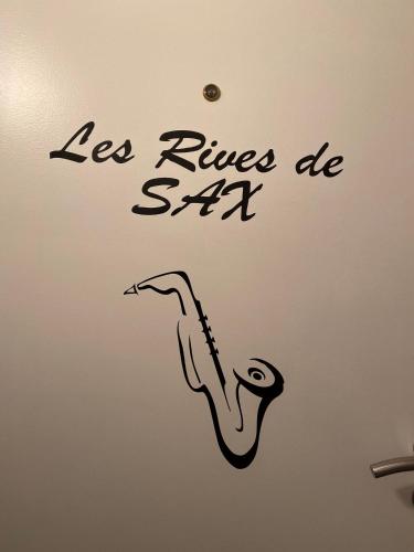 a drawing of a saxophone on a wall at Les rives de Sax in Dinant