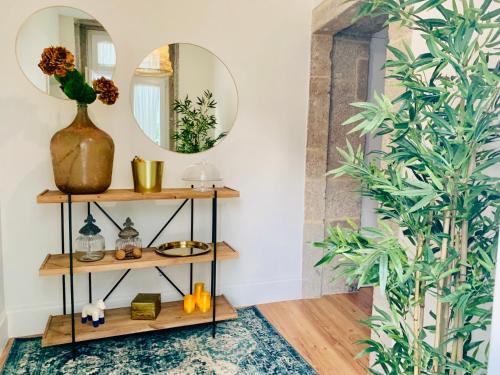a room with a mirror and a shelf with plants at The Arch - Charming Apartments in the Historic Center in Braga