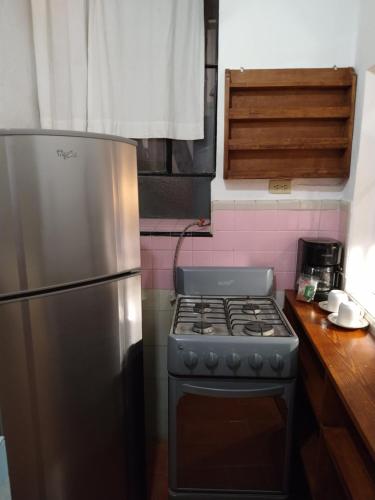 a kitchen with a stove and a refrigerator at Casa Relox 23 in San Miguel de Allende