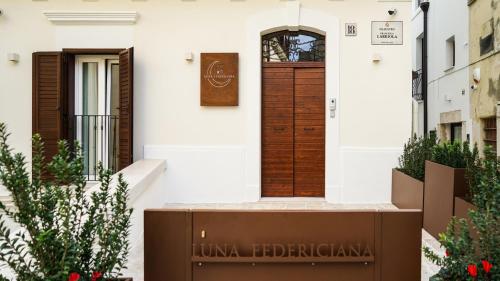 a front door of a house with a sign on it at Luna Federiciana Luxury Room & Spa in Altamura
